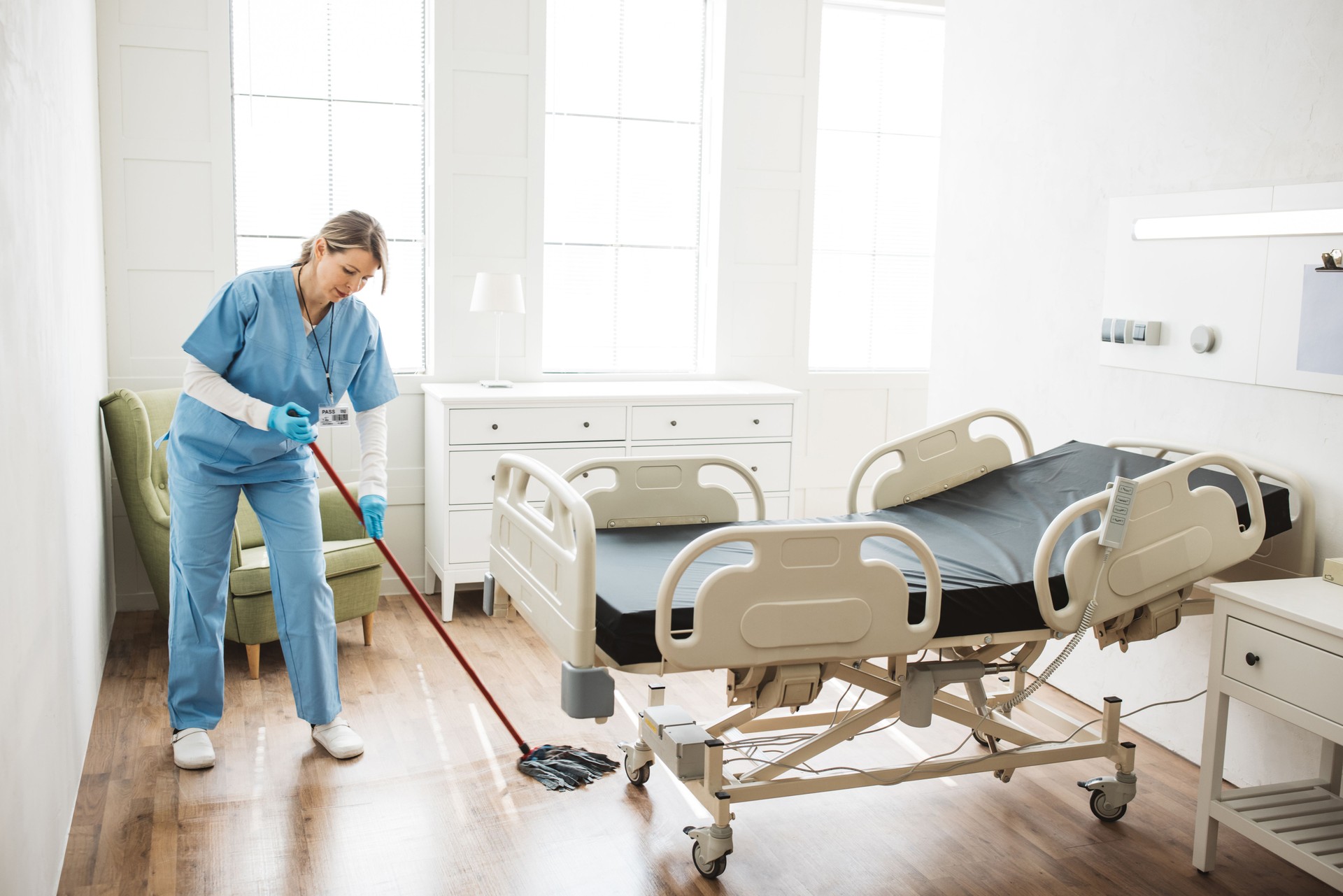 Nurse cleaning hospital ward.