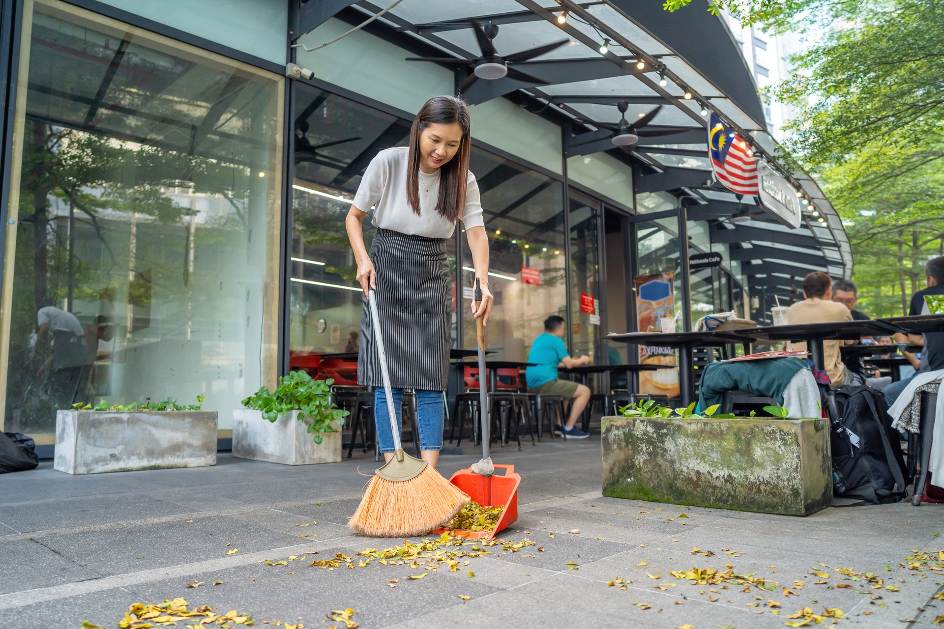Restaurant worker sweeping floor